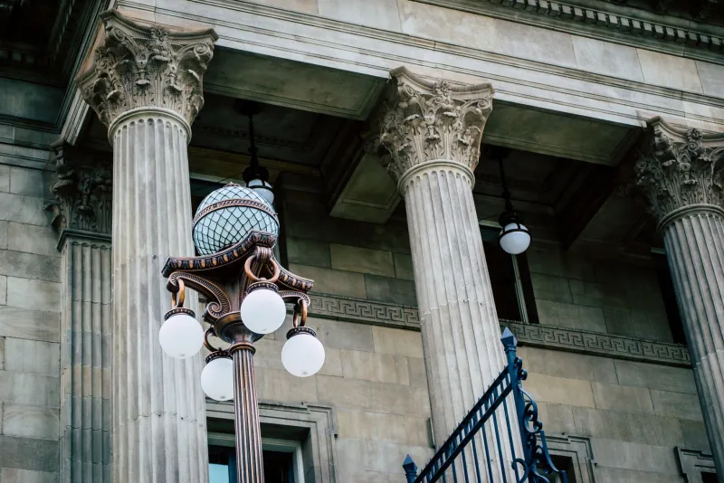 Stone columns and a lamp post outside a courthouse
