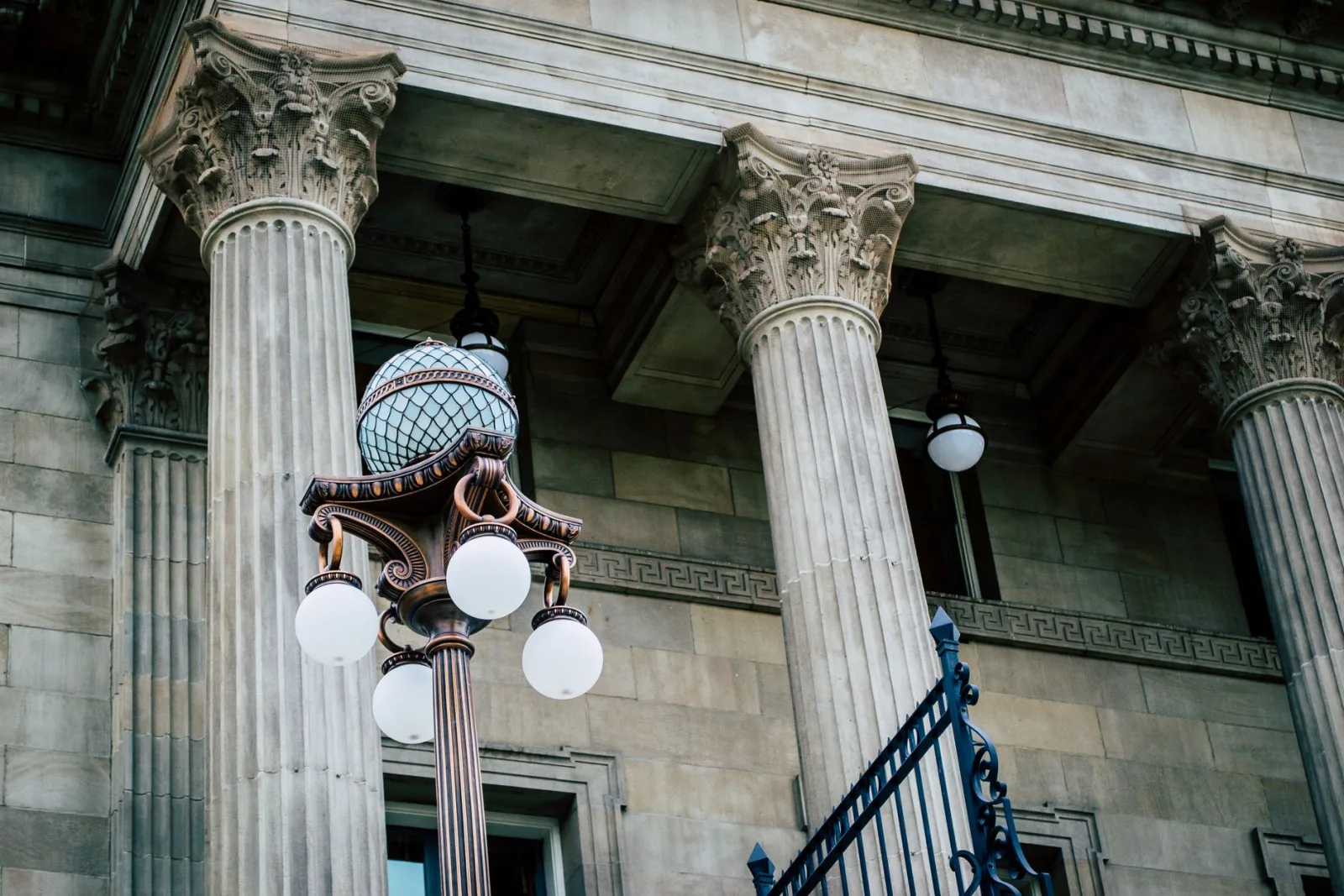 Stone columns and a lamp post outside a courthouse