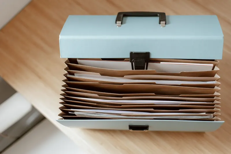 Accordion file box of organized paperwork for an identity theft case