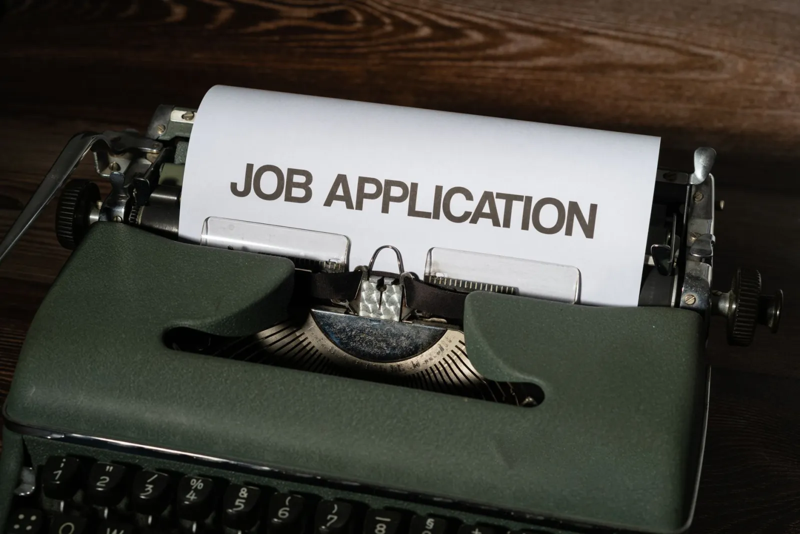 Typewriter with a sheet of paper reading job application