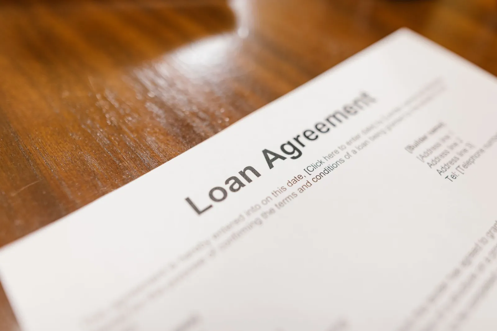A lender's loan agreement on a desk, the kind of account record furnishers report