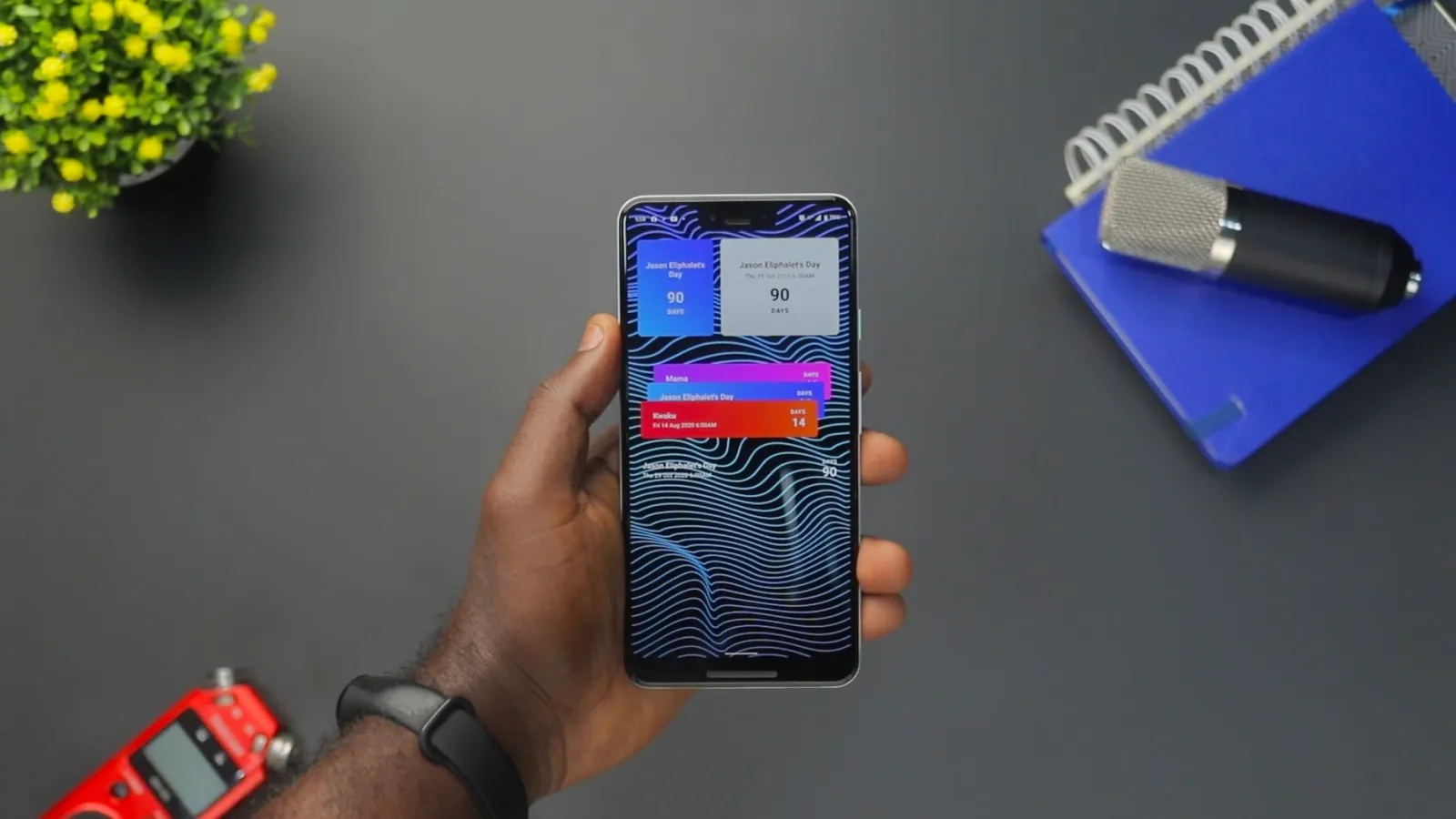 Hand holding a smartphone showing an account alert