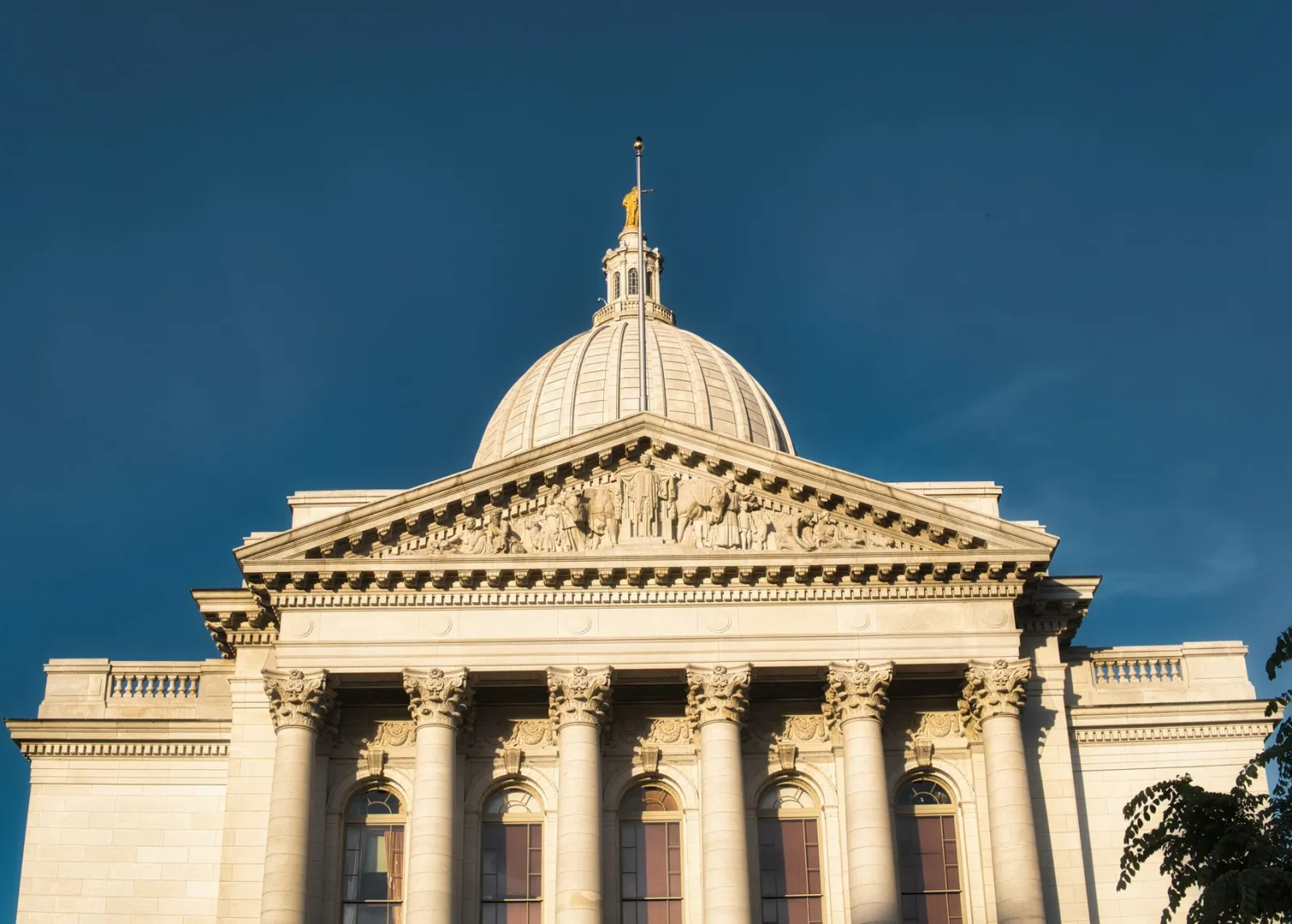 Domed capitol building against a deep blue sky